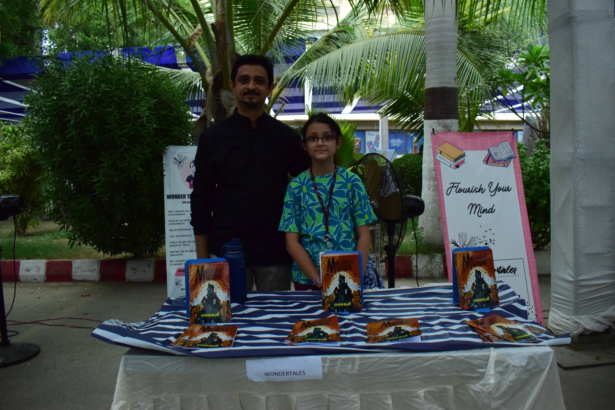 Founder and young author presenting a book at an I-Bazaar stall